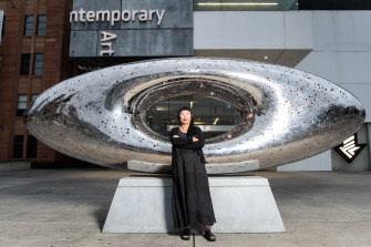 Lindy Lee with her work 'Secret World of a Starlight Ember' which is installed in the forecourt of the MCA.